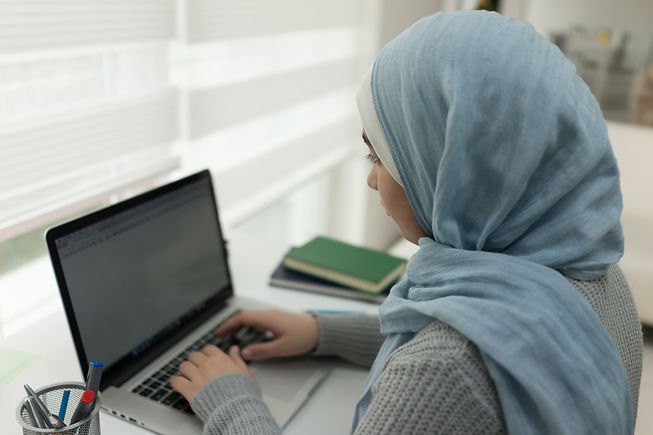 Young Muslim Girl Wotking on Laptop on D